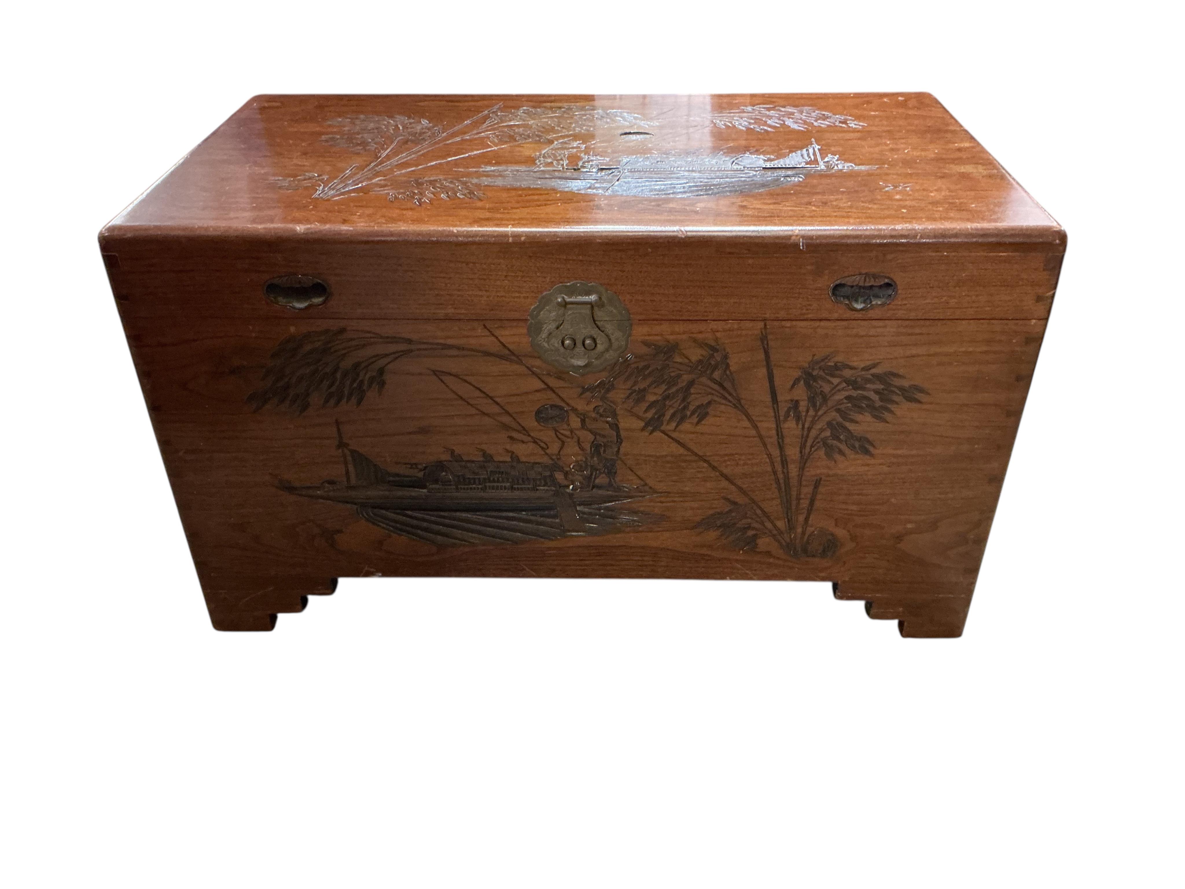 A Chinese carved camphorwood chest, width 100cm, depth 55cm, height 57cm